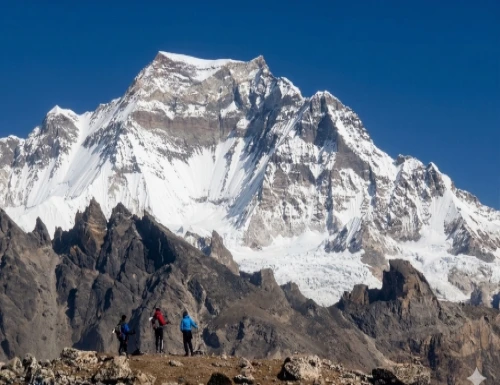 Climbers ascending a 7000 meter Himalayan peak in Nepal with snow-covered mountains and dramatic high-altitude landscape in the background