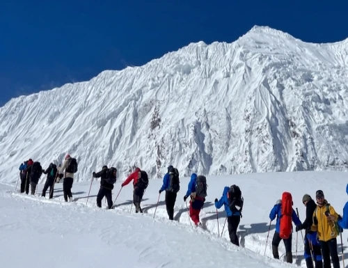 Stunning view of the Manaslu region in Nepal featuring snow-capped Mount Manaslu, traditional villages, and scenic Himalayan trekking trails