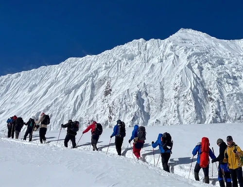 Panoramic view of the Manaslu Region in Nepal featuring snow-covered peaks, traditional mountain villages, lush valleys, and scenic trekking trails around Mount Manaslu.