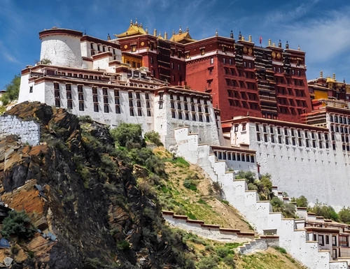 Trekking in Tibet Himalayas with panoramic mountain views, high-altitude trails, Tibetan prayer flags, and remote landscapes showcasing adventure travel in Tibet.