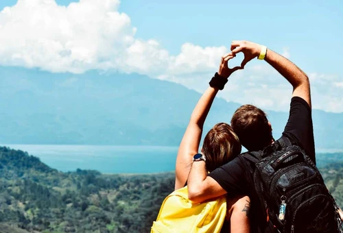 Newly married couple enjoying a honeymoon trek to Everest Base Camp with Mount Everest in the background.