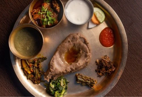 Traditional Nepali meal Daal Bhat with lentil soup, rice, and curry