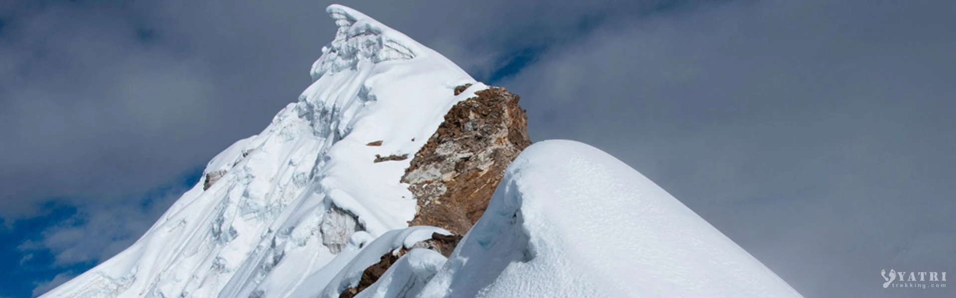 Trekkers and climbers on a snowy ridge during sunrise in the Himalayas