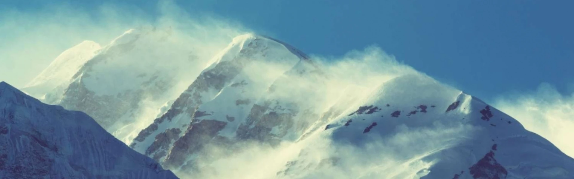Trekker walking on Himalayan trail with views of Kanchenjunga and Makalu peaks during the best trekking season in Nepal