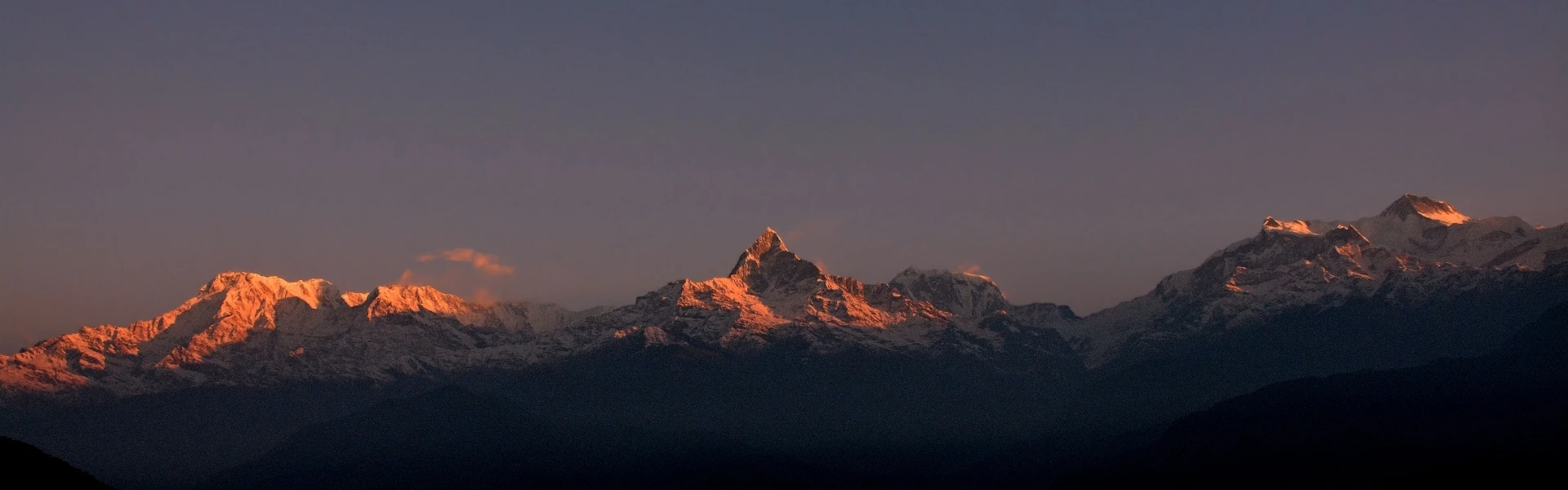 Climbers approaching a towering 7000 meter peak in the Nepal Himalayas