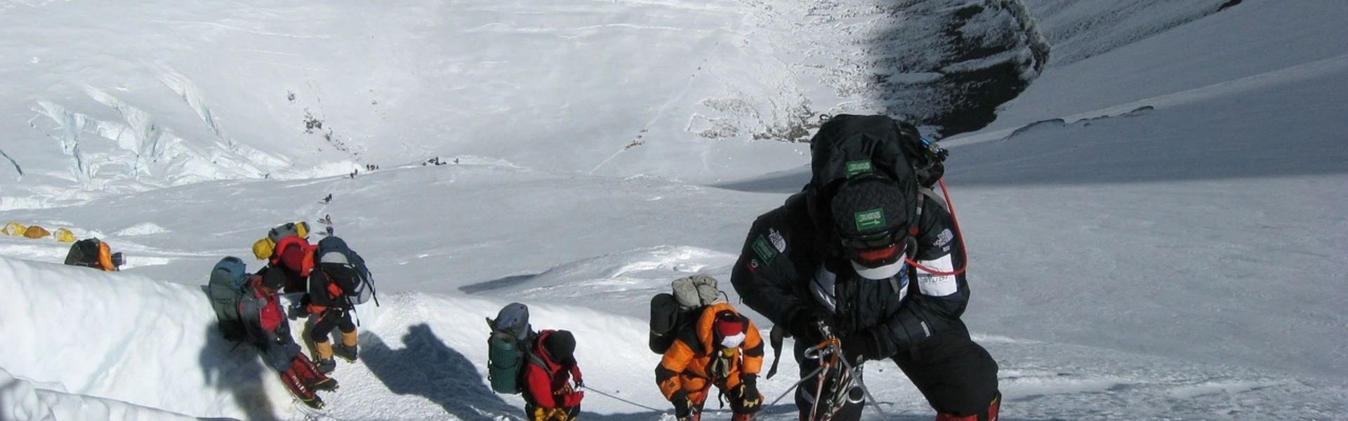 Sherpa guide assisting climber near Everest summit – New guide mandates in action