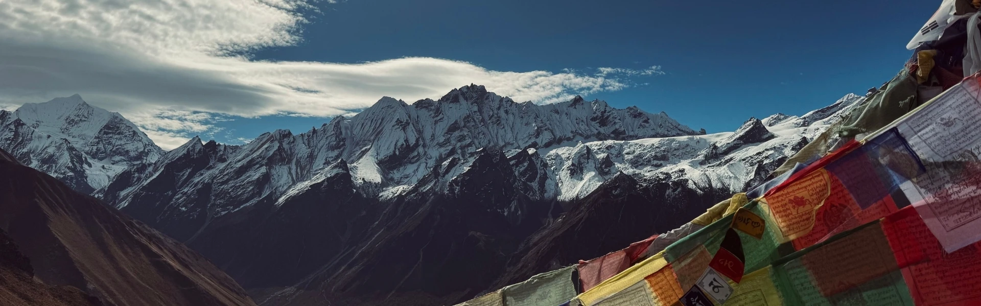 Trekkers walking through Langtang Valley with snow-covered Himalayan peaks during the best trekking season in Nepal.