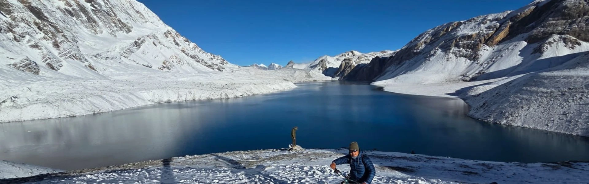 Trekker with backpack enjoying sunrise at Annapurna Base Camp, Nepal