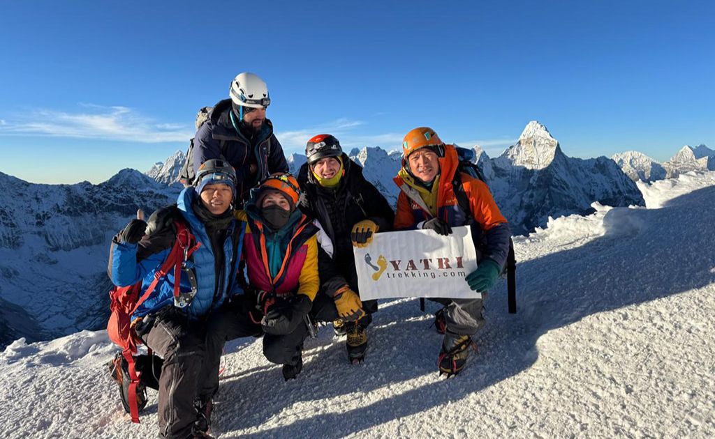 Climbers with guides celebrating at the summit of Island Peak in Nepal Himalayas