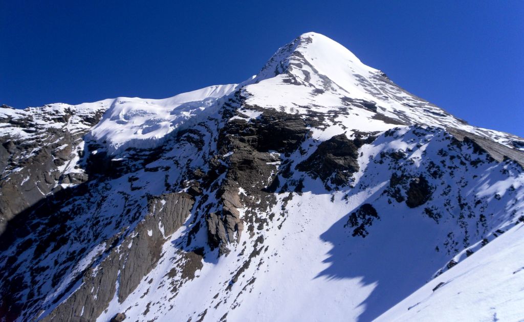 Trekker on the Annapurna Circuit trail with Pisang Peak and Annapurna II in the distance