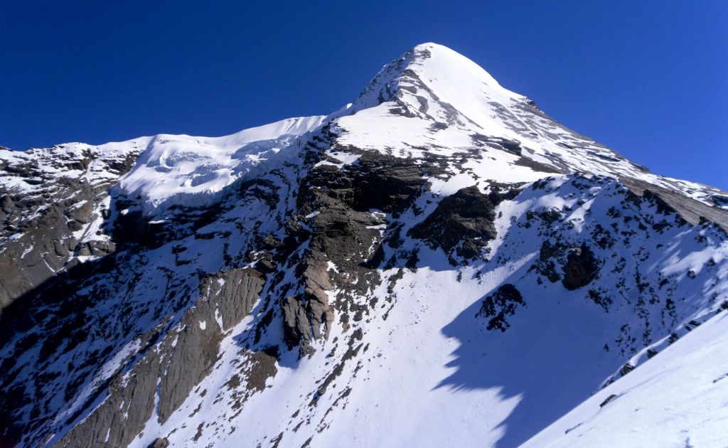 Pisang Peak rising above the Manang Valley with snow-covered slopes and surrounding Himalayan mountains in Nepal