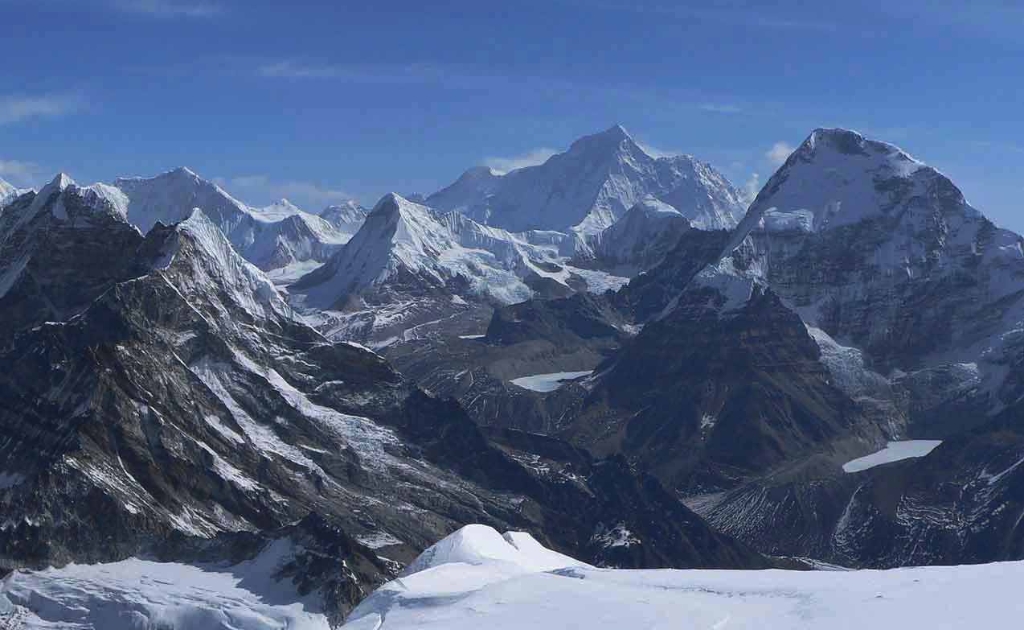 Pyramid-shaped peak of Mount Makalu rising sharply above the surrounding Himalayan landscape