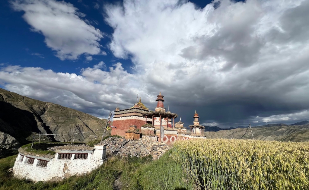 Ancient Bonpo monastery overlooking the barren Himalayan landscape of Upper Dolpo with traditional Tibetan architecture and dramatic mountain scenery.