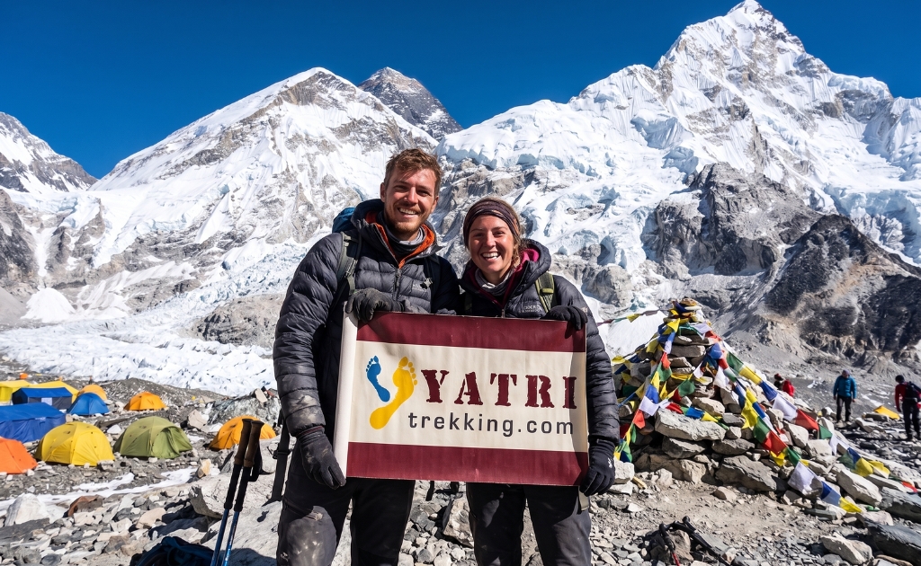 Couple trekking with a Yatri Trekking guide on the Everest Base Camp trail, enjoying a safe and memorable Himalayan adventure.