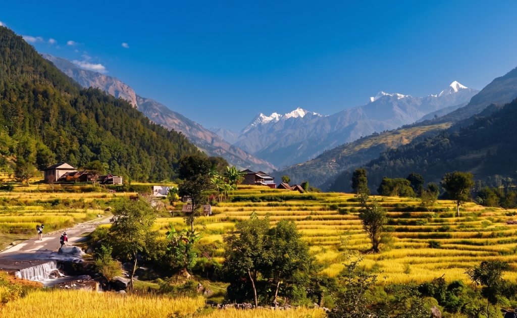 Traditional Gurung houses in Laprak village with terraced hills and mountain landscape in the Manaslu region of Nepal