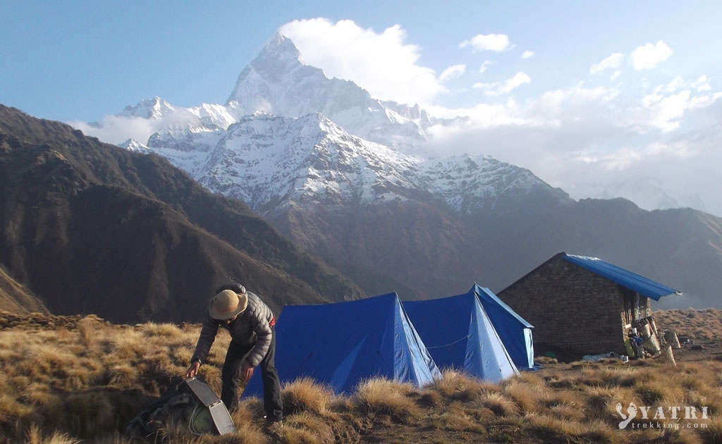 Teahouse and camping setup on the Mardi Himal Trek with Machapuchare mountain in the background in Nepal