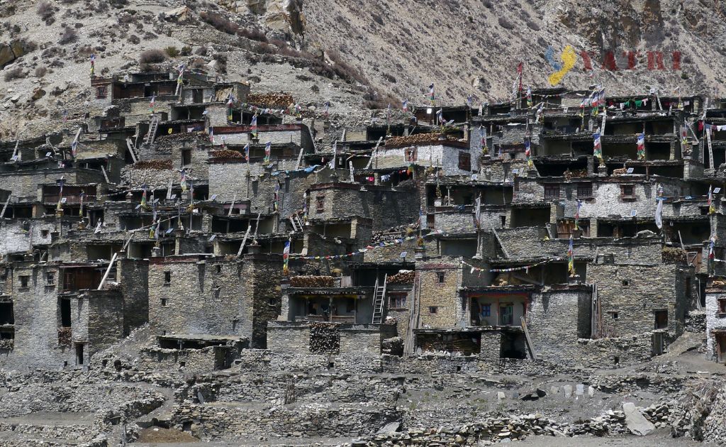 View from Naar Pass with prayer flags and Himalayan peaks in Nar Phu Valley