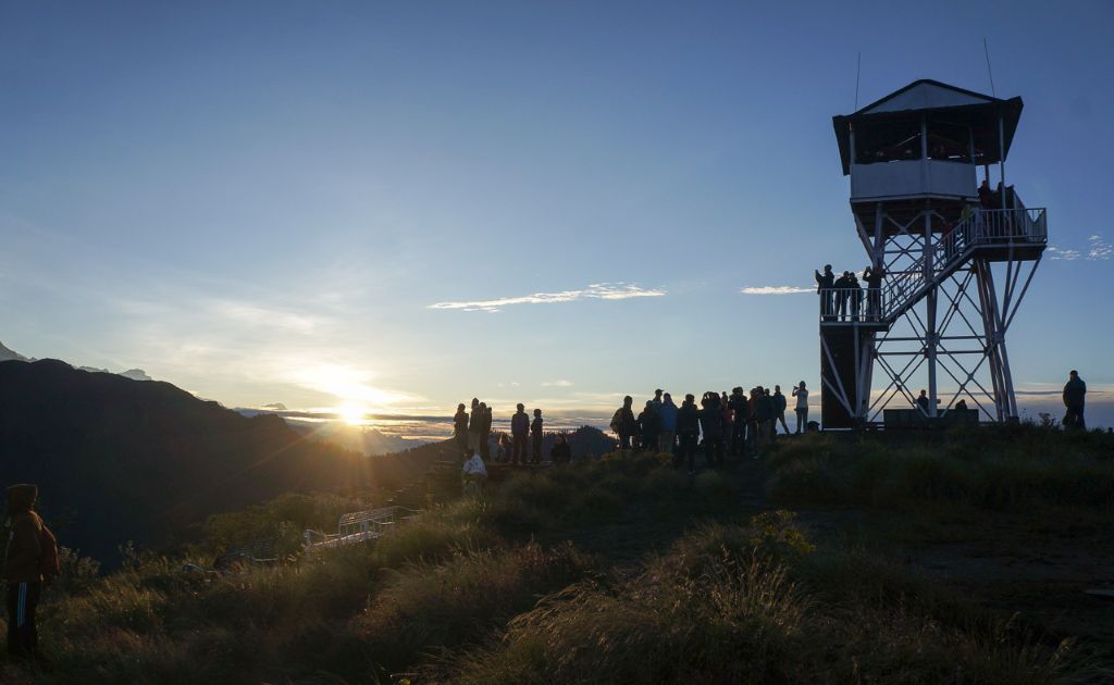 Trekkers watching sunrise from Poon Hill with Annapurna and Dhaulagiri peaks in the background